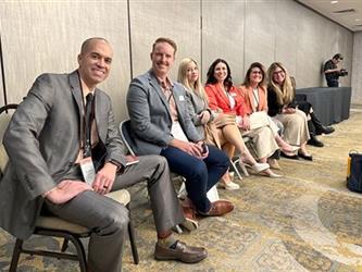 A group of SELPA staff members sitting in chairs in a breakout room