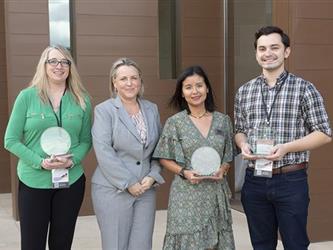 Ginese Quann with three educators of the year who are holding their awards.