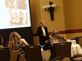 A woman presenting in front of a group.