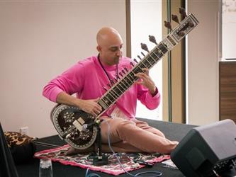 Nas Syed playing Sitar during lunch